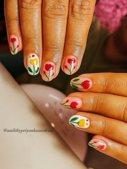 Your nails deserve a garden party too. This cute set features hand-painted red and yellow tulips on short, natural nails for a fresh and playful vibe.