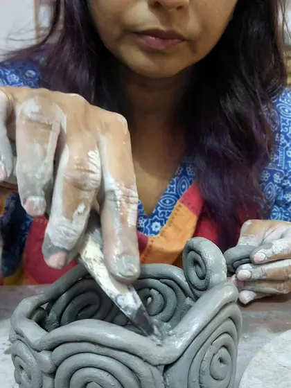 Here I am helping a student refine the details on her coiled bowl. I believe in a hands-on teaching approach, offering guidance and support at every step of the creative journey.