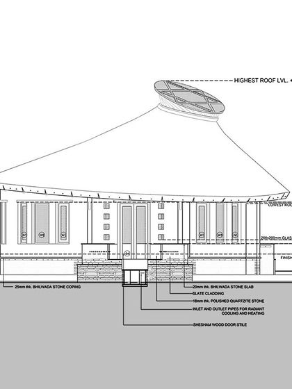The front elevation drawing for the circular yoga hall. It shows the use of Bhilwara stone for the slab and coping, demonstrating how local stone can be integrated into the foundation and plinth of a building.