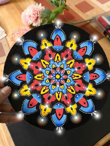 Using primary colors like red, yellow, and blue, this mandala has a playful and bright feel. I added glowing light effects digitally to give the finished piece a little extra sparkle.
