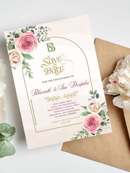 A Save the Date that is both whimsical and romantic. The design uses a soft color palette with pink and cream roses, set within a modern arch frame for a touch of contemporary elegance.