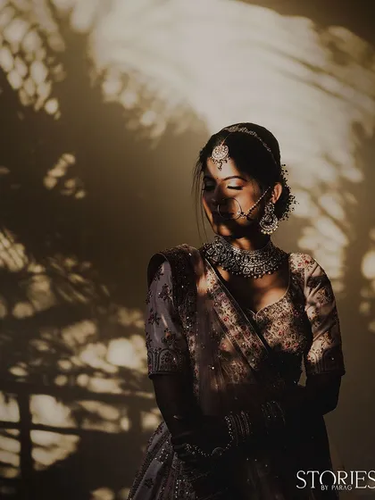 A bride bathed in the soft, dappled sunlight. I used the natural shadows of the trees to create this artistic, serene portrait, highlighting her quiet elegance and the beauty of the moment just before the ceremonies begin.