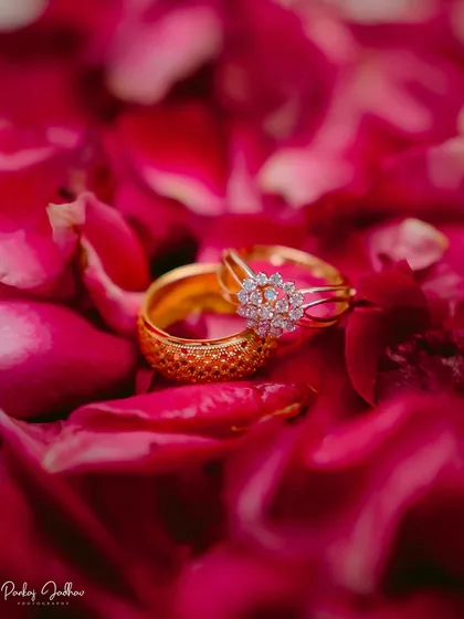 The promise, captured forever. This close-up of Ojasi and Rutvik's engagement rings nestled in rose petals highlights my focus on the small, significant details that tell your larger love story.