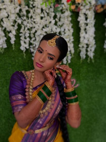 A beautiful candid moment. The makeup is bold yet balanced, ensuring she looks perfect for all the wedding rituals and photographs.