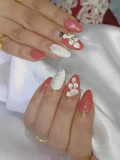 A lovely set featuring a dusty rose color, a white glitter accent nail, and 3D flowers with silver bead centers.