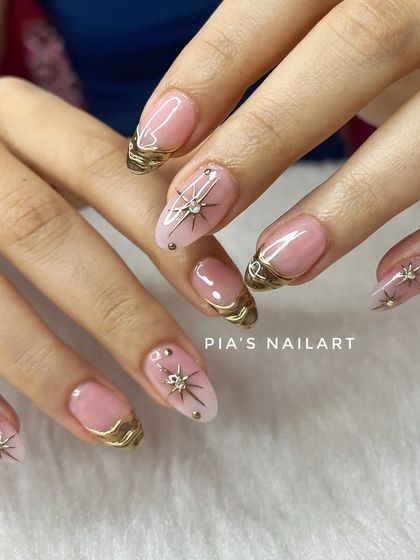 Chrome affairs. This elegant design features a sheer nude base with delicate gold chrome accents and starburst charms.