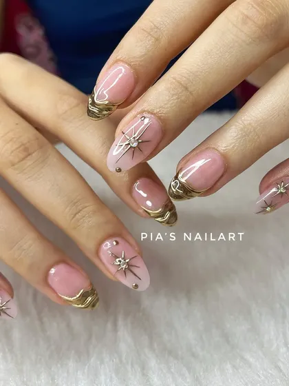 Chrome affairs. This elegant design features a sheer nude base with delicate gold chrome accents and starburst charms.