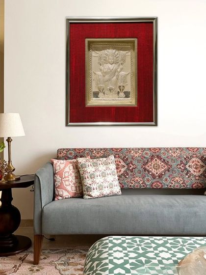 The framed silver deity installed in a client's home, adding a touch of divine elegance to their living space. The super clear museum glass ensures a reflection-free view of the intricate silverwork.