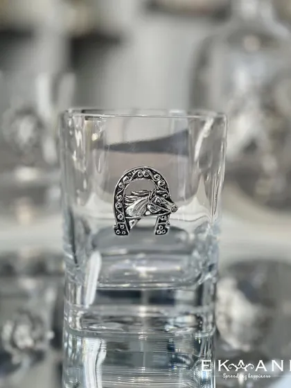 For the equestrian enthusiast, this whiskey glass is adorned with a silver-plated horse head in a lucky horseshoe. It is a unique and personal touch for your barware collection.