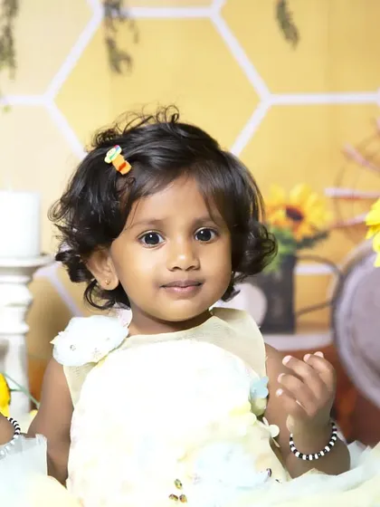 A sweet close-up from the sunflower and honeycomb themed photoshoot, capturing a gentle smile.