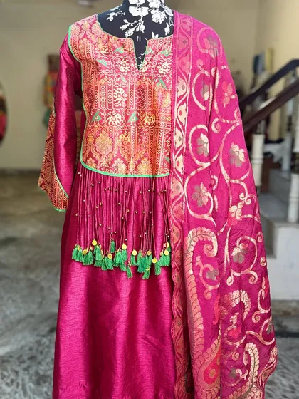 A closer look at the brocade yoke with elephant motifs and the handcrafted tassels.