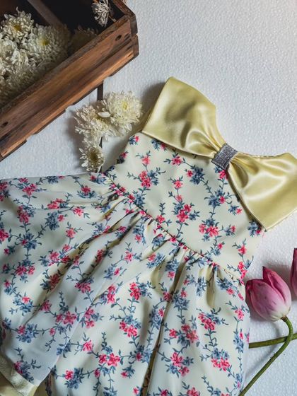 Another angle of the lemon-yellow dress, showing the large satin collar and bow. This design is all about making a cheerful and stylish statement.