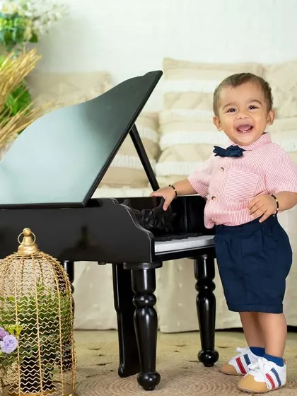 Capturing the playful spirit of a toddler is one of my favorite things. This little maestro theme, complete with a miniature piano and a dapper outfit, shows how we can turn a simple portrait session into a fun story.