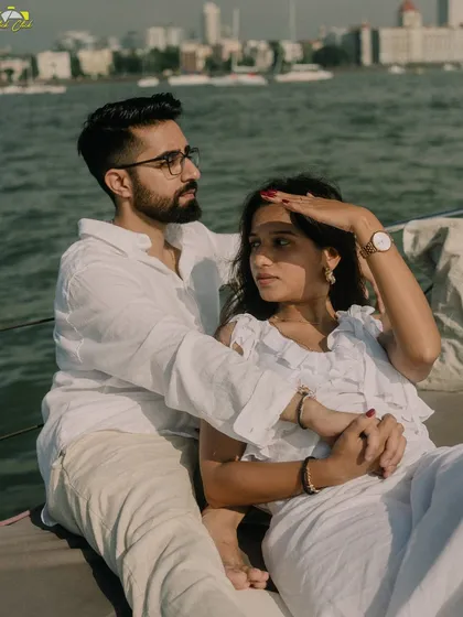 A relaxed pose on a yacht, with the couple looking out towards the Mumbai horizon.