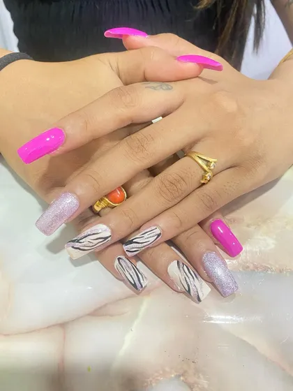 Another view of the pink and zebra print nails, showing the long, square shape.