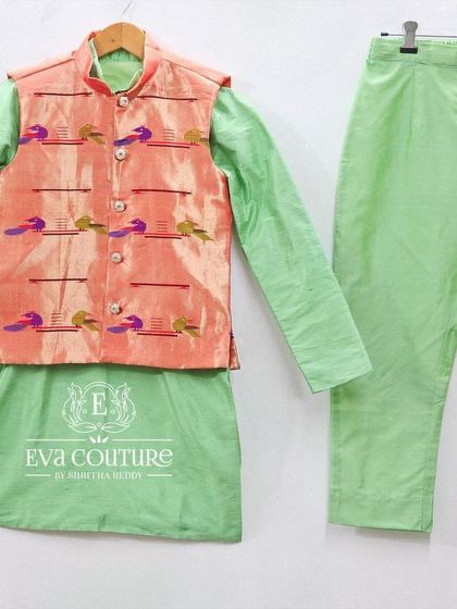 A stylish three-piece set featuring a mint green kurta and pajama, paired with a peach-colored jacket with Paithani motifs.