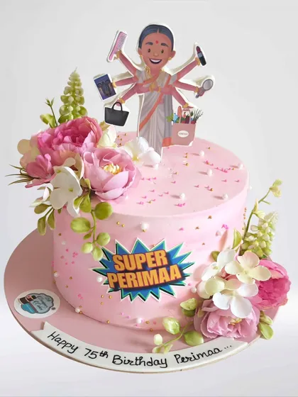 A "Super Perimaa" cake for a 75th birthday. This cake celebrates a beloved family matriarch with a custom topper and beautiful fresh flowers.
