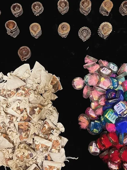 Gifting spree in progress. Here you can see the components for different bulk orders, including dry fruit potlis and colorful bangles, ready for assembly.