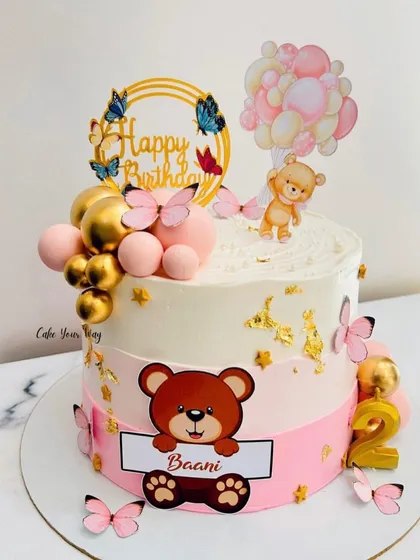 A sweet teddy bear cake for Baani's 2nd birthday. The combination of pink, gold, butterflies, and balloons creates a soft and celebratory design.
