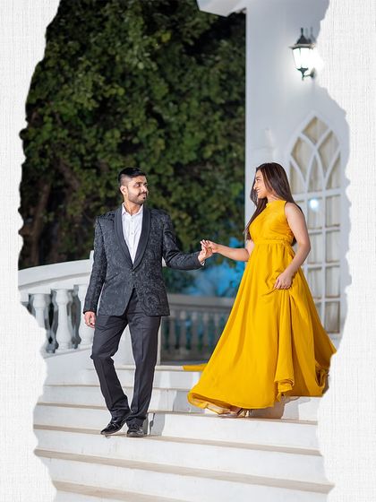 A beautiful, romantic shot on a staircase, with the woman's yellow dress adding a bright, cheerful feel to the elegant setting.