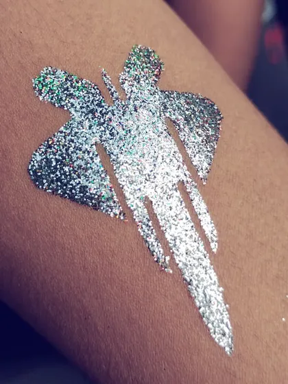 A silver glitter jet plane tattoo. This design is perfect for an airplane or transportation-themed party.