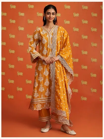 This festive mustard yellow kurta set features heavy embroidery, making it perfect for a wedding or special event. The lace-trimmed dupatta adds a final touch of elegance.