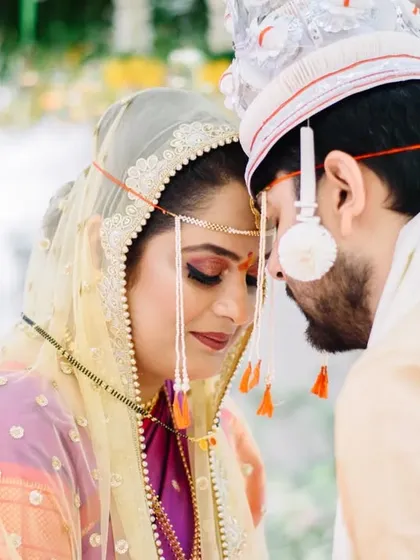 A moment of quiet connection during the wedding pheras. Prerna and Abhiroop's foreheads touching is a powerful, intimate gesture that speaks volumes about their bond during their Marathi Bengali wedding.