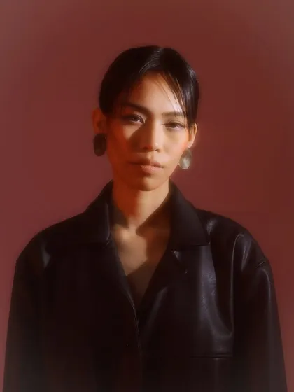 For this moody editorial portrait, I created a soft, diffused makeup look that works with the hazy, red-toned lighting. The focus is on a natural skin finish and subtly defined features to enhance the model's expression.