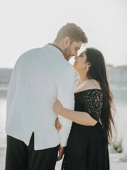 A romantic portrait from behind, focusing on the couple's embrace and the beautiful light.
