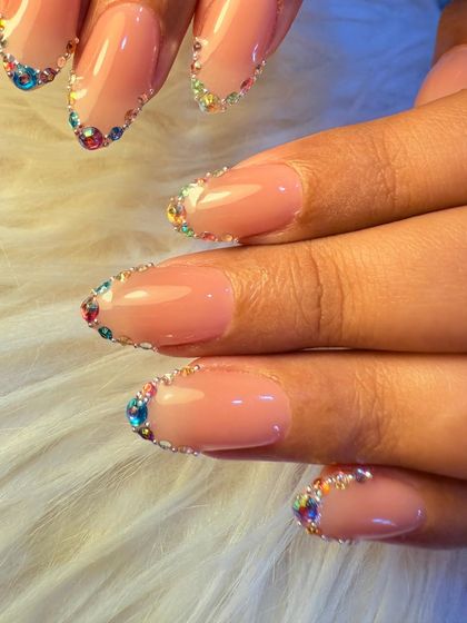 For a touch of sparkle, we created this beautiful design featuring a rainbow of tiny crystals lining the cuticle. It's a simple yet glamorous way to add color and shine to a neutral manicure.