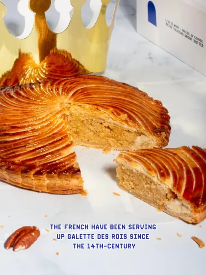 A slice of the Galette des Rois, showing the thick layer of almond cream filling.