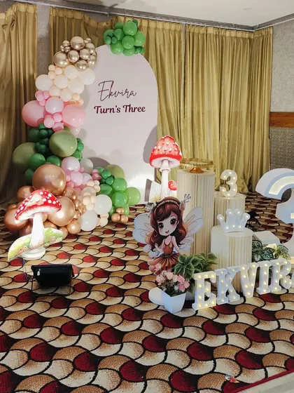 A wider view of the fairy party setup, showing the placement of the large number '3' prop.