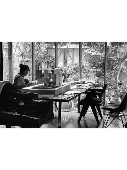 The model-making table in our studio, surrounded by views of the garden. This environment, where the act of creation is immersed in nature, directly influences our architectural philosophy.