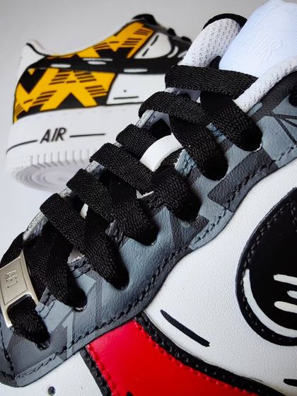 A custom pair for an Arsenal fan, combining two iconic jerseys. This detail shot shows the 22-23 away jersey pattern on the eyestays, with a cartoon-style outline.