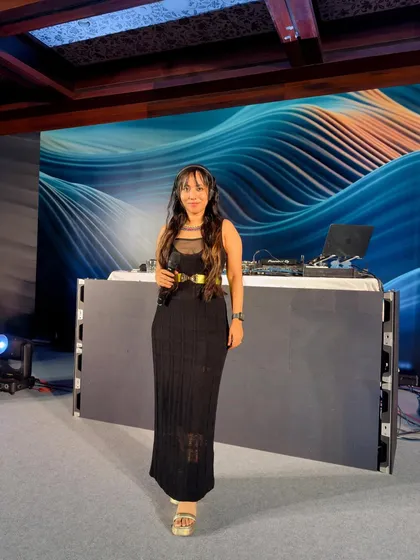 A full-length shot at a private party, showing how I coordinate my attire with the event's sophisticated black-tie feel. The setup included a large LED backdrop.