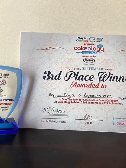 The trophy and certificate for my "One Tier Wonder" celebration cake. These awards motivate me to keep creating and sharing my passion.
