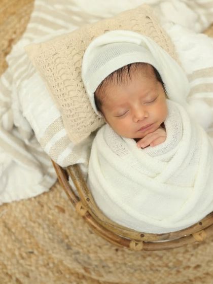 A bundle of joy in a cozy basket. The overhead view is perfect for capturing the symmetry and peace of a sleeping newborn.