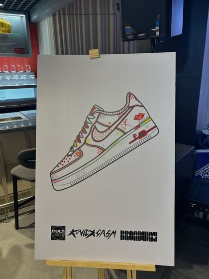 A branded art canvas on an easel, ready for guest interaction at the Broadway event. This is a key part of our interactive experience, inviting attendees to co-create with us.