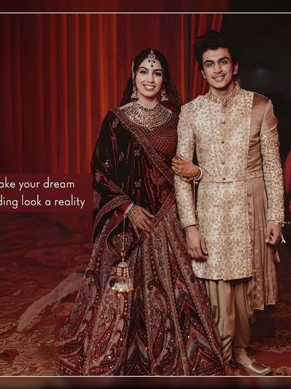 Make your dream wedding look a reality. This couple looks regal in a deep red velvet lehenga and a coordinated gold sherwani, a perfect match for a grand celebration.