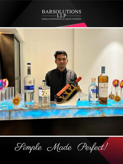 A sleek, backlit bar setup perfect for a contemporary home celebration, stocked with premium gin, vodka, and whisky.