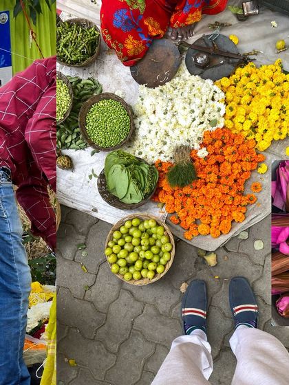 A top-down view of a flower and vegetable seller's setup on the pavement, a colorful and organized display.