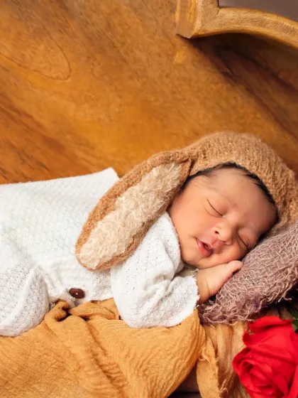 Our own son, Aariv, as a newborn. This little bunny is sleeping soundly, showing a glimpse into the personal passion we bring to our work.