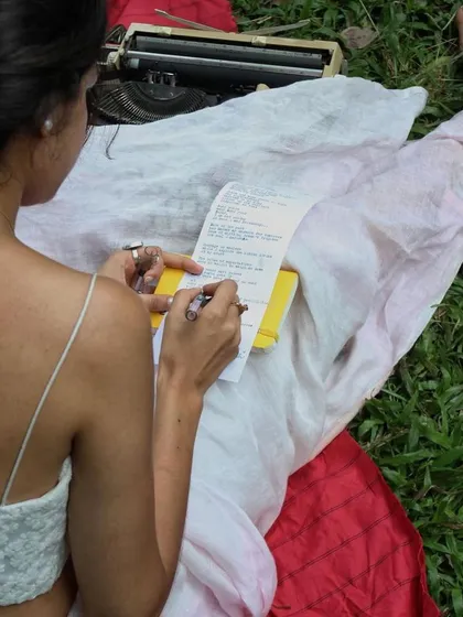 Signing a freshly typed poem. This act of putting my name to the words is a final, personal touch, a promise of authenticity and a seal of the connection we just shared.