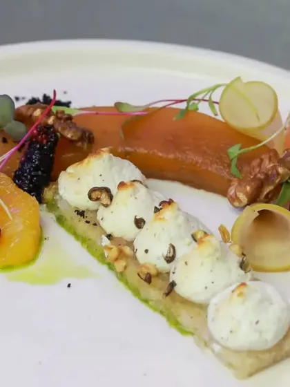 I love creating unique flavor combinations. This dish features wild forest honey-roasted goat cheese with compressed musk melon, fresh greens, and roasted walnuts. It's an explosion of tastes on one plate.