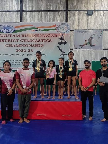 Our gymnasts and coaches on the podium. Teamwork makes the dream work.