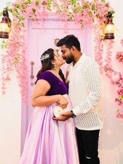 A romantic kiss shared during a maternity shoot in front of our lavender door. This image showcases the love and connection that I strive to capture for every couple.