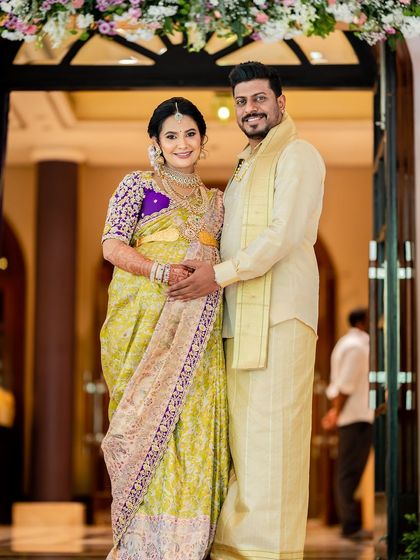 A full-length portrait of the couple at their baby shower. Their outfits were designed to be both traditional and comfortable for the special occasion.