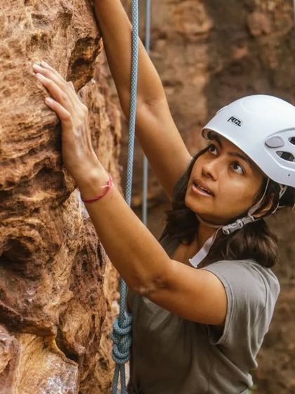 A moment of focus and determination. Roped climbing teaches you to trust yourself and stay calm, even when you're high off the ground.