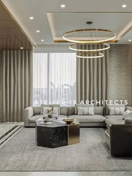 For this living room in Noida, we used a large L-shaped sofa to maximize comfort, complemented by a marble TV unit and a striking three-ring chandelier. The design focuses on creating a modern, luxurious space for family life.