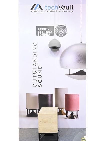 A display at our booth showcasing our partnership with Architettura Sonora, a brand known for its "Outstanding Sound" and artistic speaker designs. We partner with the best in the industry to offer our clients exceptional products.